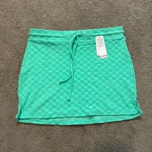 XS mini skirt swimsuit cover up. Polyester material.